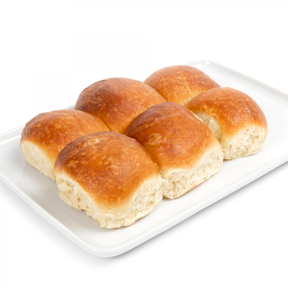 Six brioche rolls on a platter