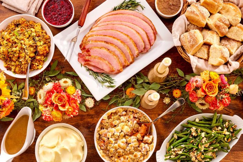 Holiday traditional meal with ham and sides that serves 4-6 people served on a holiday decorated table