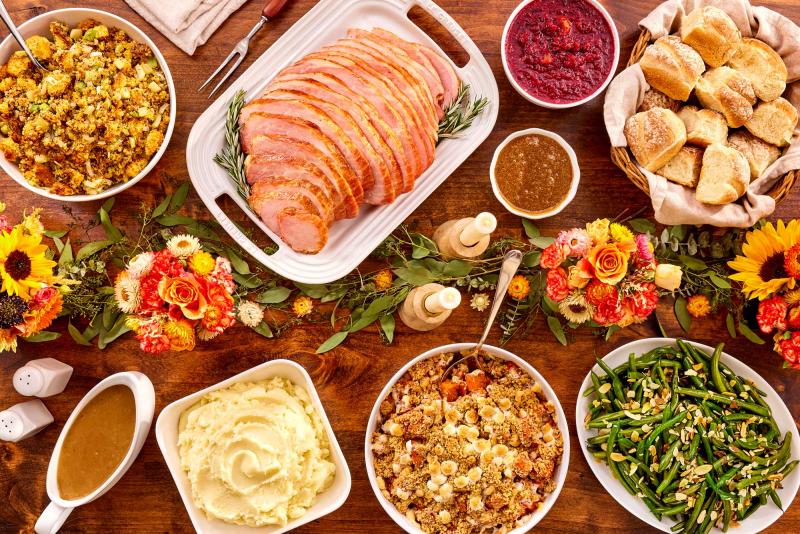 Holiday traditional meal with ham and sides that serves 4-6 people served on a holiday decorated table