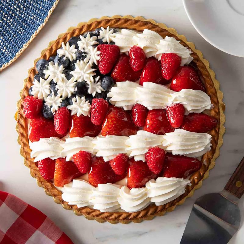 Fruit tart with in the style of the United States flag with blueberries and strawberries