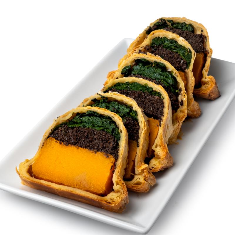 Sliced began butternut squash Wellington on a white serving platter